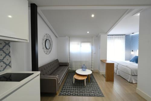 a small living room with a bed and a table at LEÓN SUITE Urban Studios in León