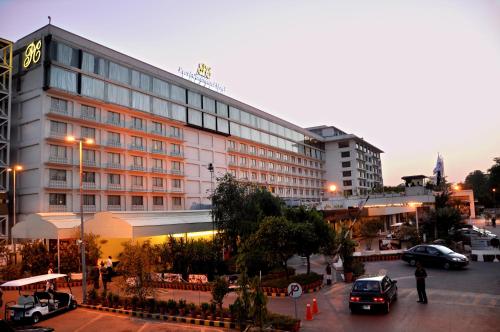a large building with cars parked in front of it at Pearl Continental Hotel, Lahore in Lahore