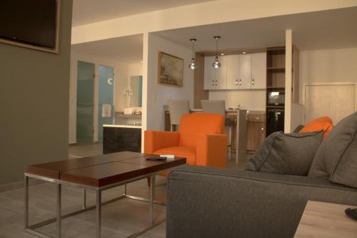 a living room with a couch and a table at Hangar Inn Guadalajara Aeropuerto in Guadalajara