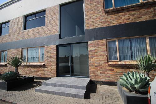 a brick building with stairs in front of it at Portside 2 in Walvis Bay