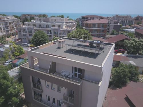 an aerial view of a white building in a city at Ivatea Family Hotel in Ravda