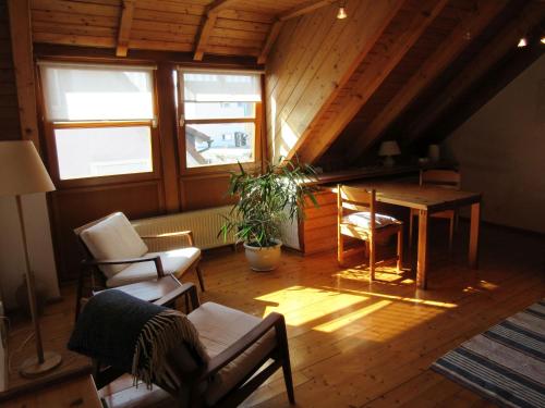 a living room with a table and chairs in a attic at Gästezimmer Paul in Lindau