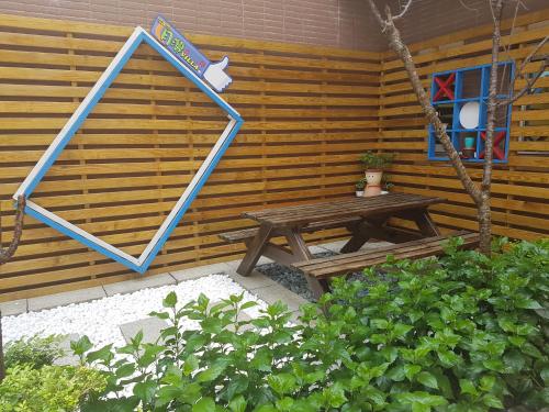 a wooden cabin with a picnic table and a window at Moon Villa in Zhongpu
