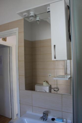 a bathroom with a sink and a mirror at Apartmani Vinko Bol in Bol