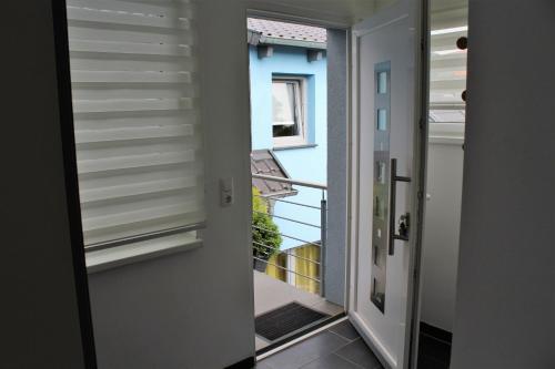 a door leading into a room with a balcony at Ferienwohnung am Park in Erfurt