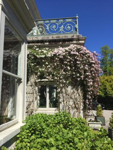 a building with a window with flowers on it at Ballyteige Lodge in Ballyteige Bridge