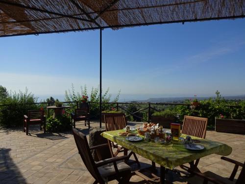 a green table with chairs on a patio at Alberto's Mt.Etna B&B in Zafferana Etnea