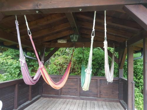 a group of hammocks hanging from a roof at Apartments Landhaus Sonnheim in Lofer