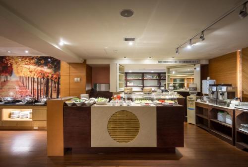 a large kitchen with a counter with food on it at Waikoloa Hotel in Taipei