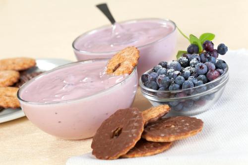 a table with a plate of blueberries and a bowl of dip at Grand Hotel Trieste & Victoria in Abano Terme