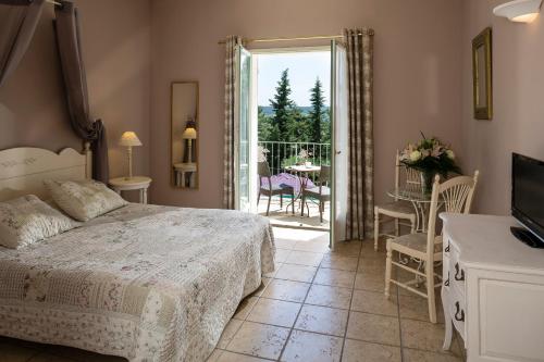 a bedroom with a bed and a balcony with a table at Hotel Restaurant Le Clos De Pradines in Saint-Quentin-la-Poterie