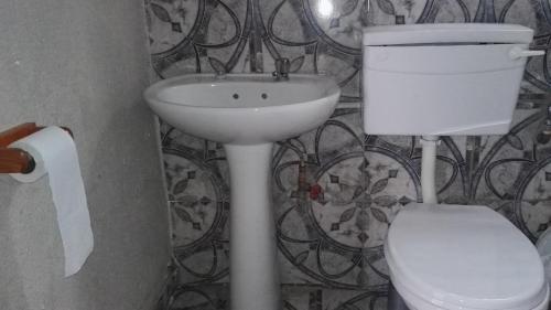 a bathroom with a white sink and a toilet at Fourties Guest House in Phalaborwa