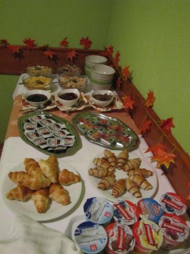 a table topped with plates of pastries and other food at Hotel Hubert Nové Zámky in Nové Zámky