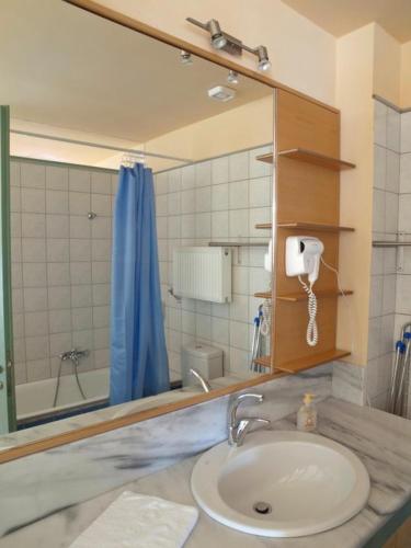 a bathroom with a sink and a mirror at Sorta Apartments in Kato Daratso