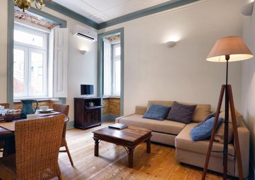 a living room with a couch and a table at Casas de São Bento in Lisbon