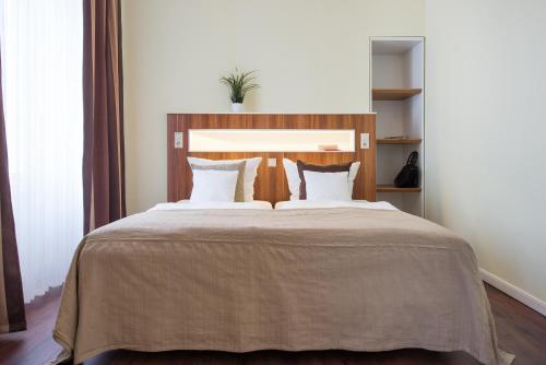 a bedroom with a large bed with white pillows at Hotel Stralsund in Stralsund