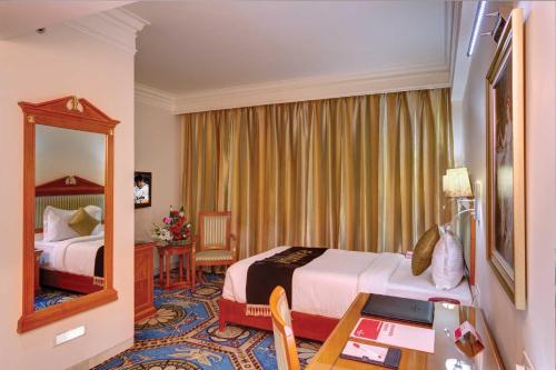 A bed or beds in a room at Ramada By Wyndham Amritsar