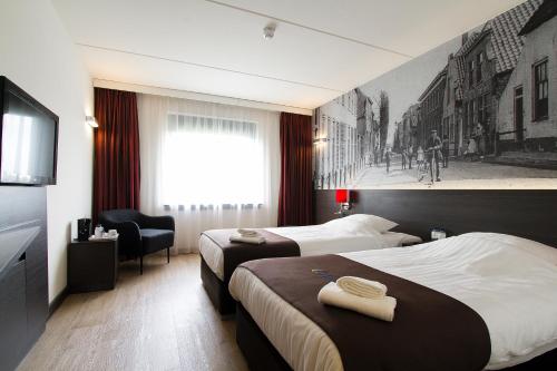 Tempat tidur dalam kamar di Bastion Hotel Zoetermeer