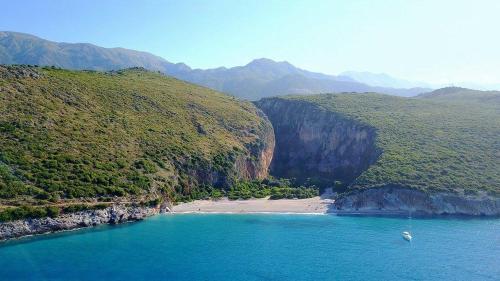 an aerial view of a beach next to a mountain at Villa Filip in Vuno