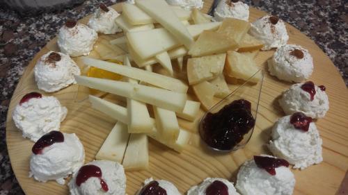 a plate of food with cheese and desserts on it at Agriturismo San Vito in Crocemaroggia