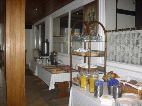 a restaurant with a table with food on it at Hotel Europa in Holsthum