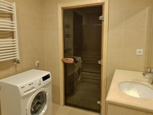 a bathroom with a washing machine and a sink at Crystal Town House in Bakuriani