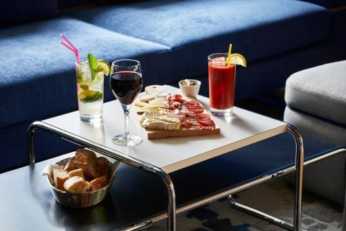 a table with a tray of food and drinks on it at YOOMA Urban Lodge Tour Eiffel in Paris