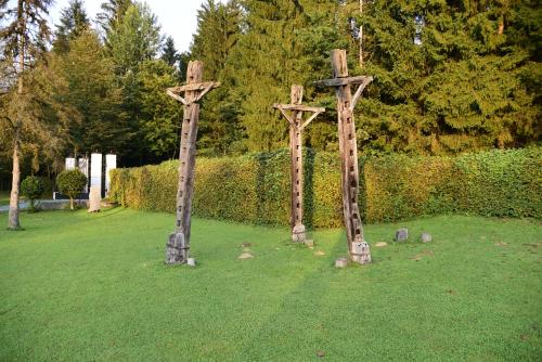 two crosses standing in the grass in a field at Glamping FOREST EDGE in Kamnik