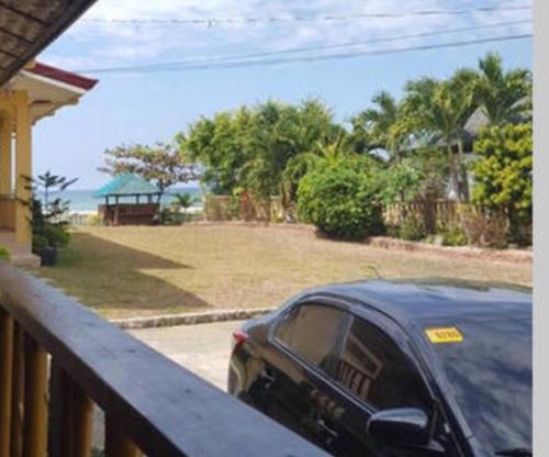 a car parked on the porch of a house at Seabreeze Beachfront Home and Cottages new management in San Juan