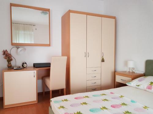 a bedroom with a desk and a bed and a desk at Villa Spanjol in Rab