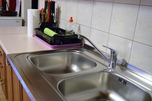 a kitchen sink with a faucet next to it at Apartment Racing in Beli Manastir