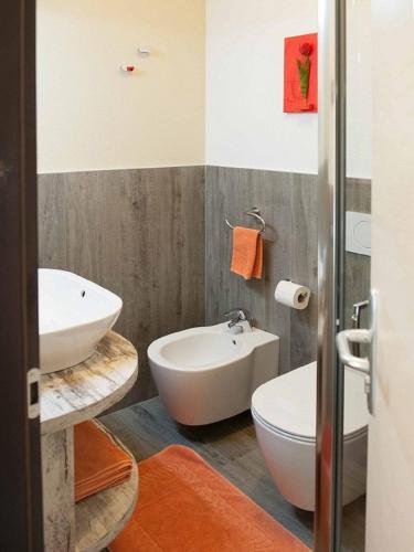 a bathroom with a white sink and a toilet at Lucas Haus in Livigno