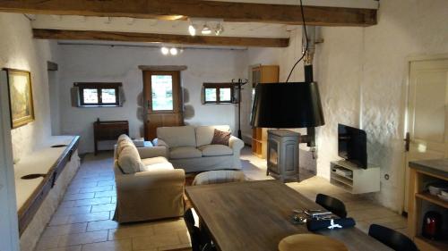a living room with a couch and a table at Champ de la Fontaine in Brassy