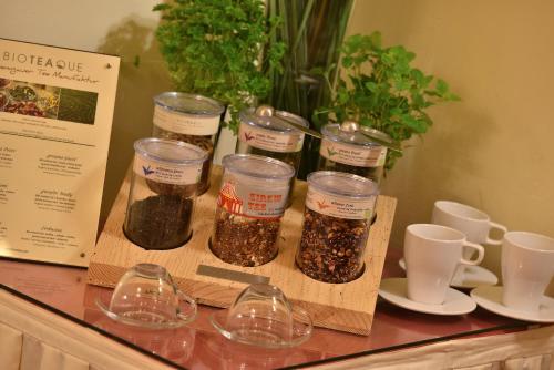 a counter with four jars of spices on a table at Angelis in Prague