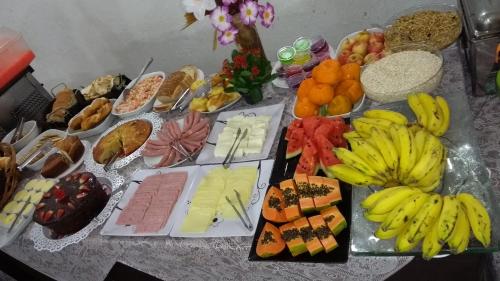 a table with a bunch of different types of food at Grande Hotel Renascença in Juiz de Fora