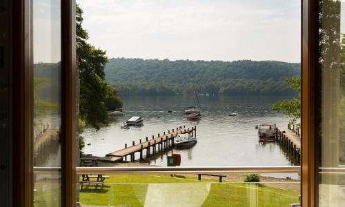 a view of a lake with boats in the water at Hill Of Oaks in Windermere