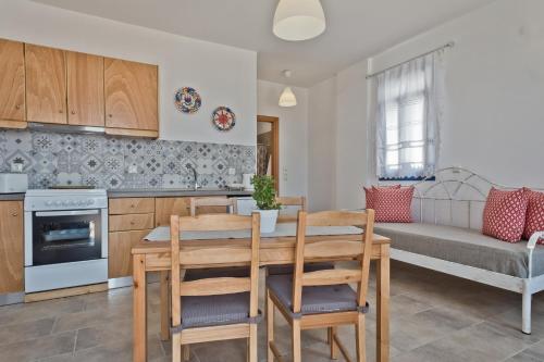 a kitchen and living room with a table and chairs at Alisachni Villas in Lefkos Karpathou