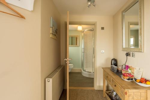 a bathroom with a sink and a toilet in a room at The Sail Loft in Southwold