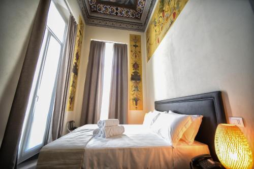 A bed or beds in a room at Hotel Palazzo Vannoni