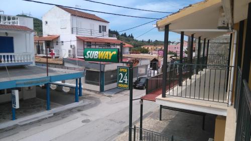 an empty street in a town with a sign that says subway way at Anna's flat in Kavos