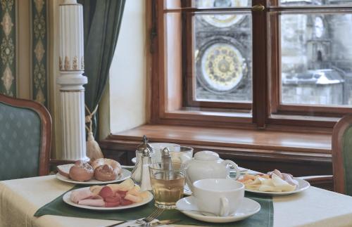 a table with plates of food on top of it at Grand Hotel Praha in Prague