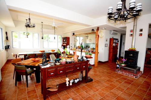 a kitchen and dining room with a table and a stove at Coastline Azure B&B in Donghe