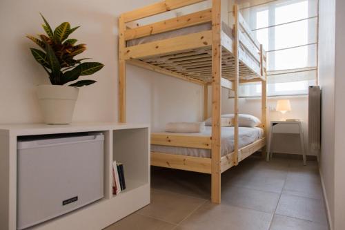 a bedroom with a bunk bed in a room at Mondello Martini in Mondello