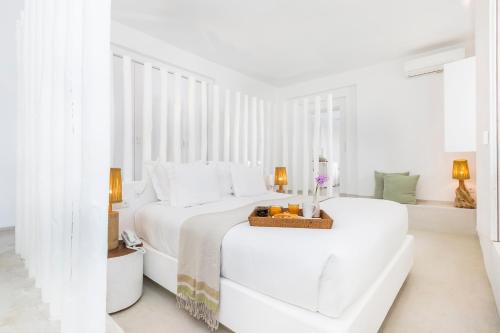 a white bedroom with a bed and a couch at Octant Vila Monte in Moncarapacho