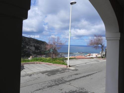 a view of the ocean from a street with a street light at Buggerru a Mare Residence in Buggerru