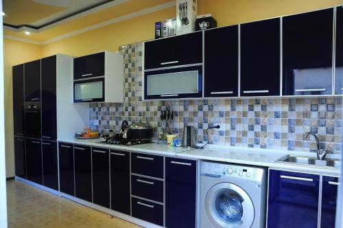 A kitchen or kitchenette at Mukhlisabegim Hotel