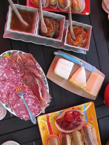 a table with plates of meat and other foods at Mas Du Roc Bed & Breakfast in Grasse