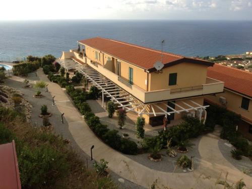 an aerial view of a house with the ocean in the background at Chic Apartment in Parghelia Italy in Parghelia
