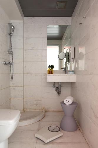 a bathroom with a sink and a toilet and a mirror at Dorian Inn - Sure Hotel Collection by Best Western in Athens