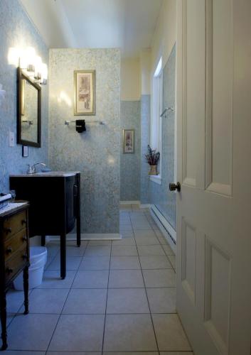 a bathroom with a sink and a tub and a toilet at Inn at the Agora in Lewiston